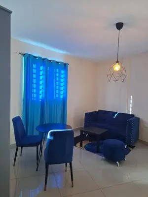 a living room with a couch and a table and chairs at Doña Minda Home in Naiboa