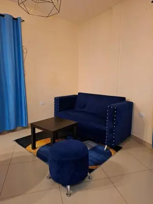 a living room with a blue couch and a table at Doña Minda Home in Naiboa