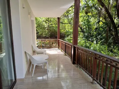 a balcony with two chairs and a table on it at Gorgeous large condo, quiet beachfront complex in Las Terrenas