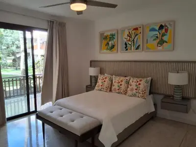 a bedroom with a bed with pillows and a window at Gorgeous large condo, quiet beachfront complex in Las Terrenas