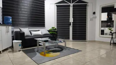 a living room with a couch and a table at 1BR Studio with Pool, Fast Wi-Fi, Walk to Beach in Sosúa