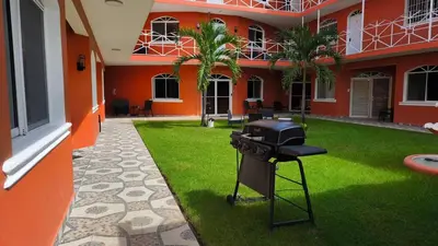 a grill in the courtyard of a building at 1BR Studio with Pool, Fast Wi-Fi, Walk to Beach in Sosúa