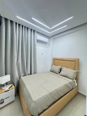 a bedroom with a bed in a room with a window at Hotel Evers in Azua