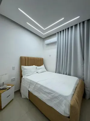 a bedroom with a bed and a window with at Hotel Evers in Azua