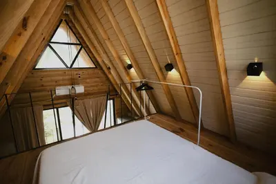 a large bed in a room with a window at Casa Cayena - Hibiscus House in El Valle