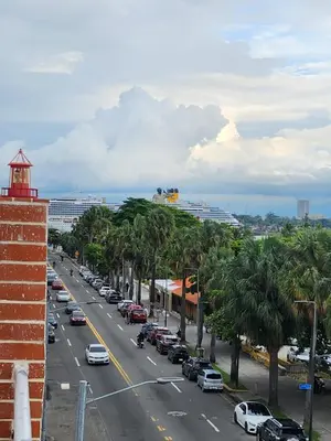 a street with cars parked on the side of the road at Hotel La Llave Del Mar in Santo Domingo