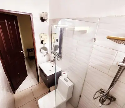 a bathroom with a toilet and a sink at Hotel La Llave Del Mar in Santo Domingo