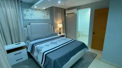 a bedroom with a king sized bed in a room at D Gomez House in Santiago de los Caballeros