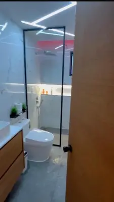 a bathroom with a toilet and a sink at D Gomez House in Santiago de los Caballeros