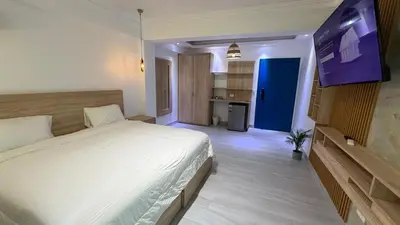 a bedroom with a bed and a flat screen tv at Hotel Juan Dolio in Juan Dolio