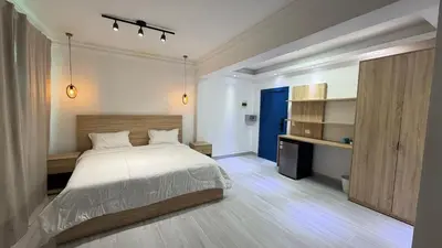 a bedroom with a large bed and a desk at Hotel Juan Dolio in Juan Dolio