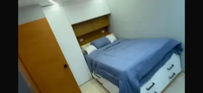 a small bedroom with a blue bed in a room at Dgomez House in Santiago de los Caballeros