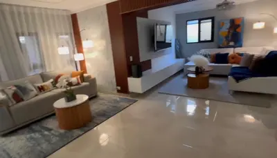 a large living room with couches and a tv at Dgomez House in Santiago de los Caballeros