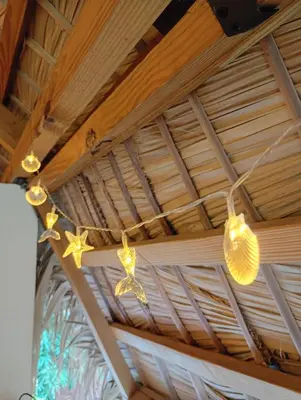 a string of lights hanging from a ceiling at Mejor, Quédate Aquí in Las Galeras