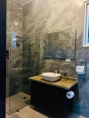 a bathroom with a sink and a shower at Villa Reyes Vega - Private Pool & BBQ - La Colonia, SC in La Cabirma