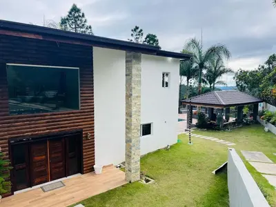 a house with a large window on the side of it at Villa Reyes Vega - Private Pool & BBQ - La Colonia, SC in La Cabirma