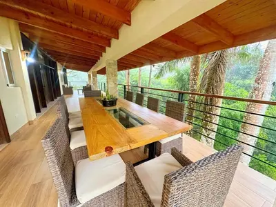 a dining room with a wooden table and chairs at Villa Reyes Vega - Private Pool & BBQ - La Colonia, SC in La Cabirma