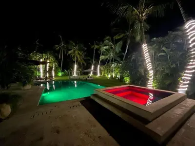 a swimming pool at night with a red tub at Villa Reme 19 in La Romana