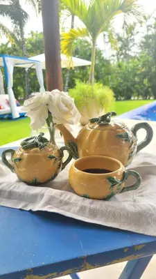 two tea pots and a vase with a flower on a table at Villa Reme 19 in La Romana