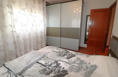 a bedroom with a bed and a curtain and a window at Casamesa-14 in Los Alcarrizos