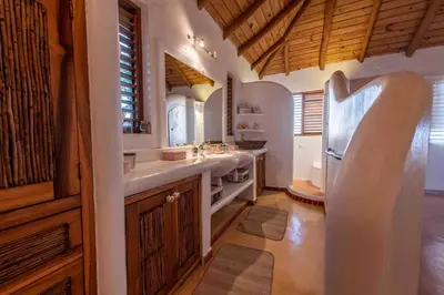 a kitchen with a sink and a refrigerator at 5BR Serendipity Pool Ocean View Jungle in Las Terrenas