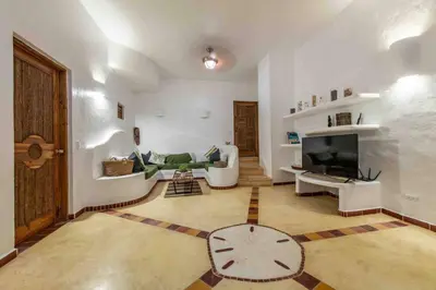 a living room with a tv and a couch at 5BR Serendipity Pool Ocean View Jungle in Las Terrenas