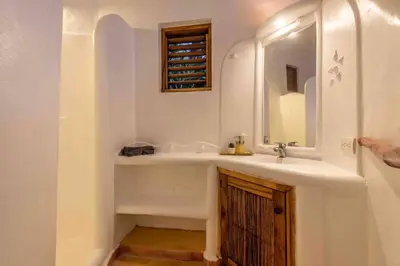 a bathroom with a sink and a mirror at 5BR Serendipity Pool Ocean View Jungle in Las Terrenas