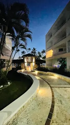a building with a palm tree in front of a building at vista paraiso del mar in Villas del Mar