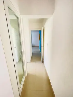 a long hallway with a door and a mirror at vista paraiso del mar in Villas del Mar