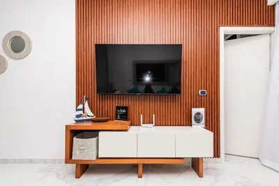 a bathroom with a sink and a tv on a wall at Luxury 2BR Private Jacuzzi CanaRock Star Punta Cana in Punta Cana