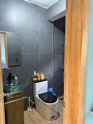 a bathroom with a toilet and a sink at Villa Mis Núñez