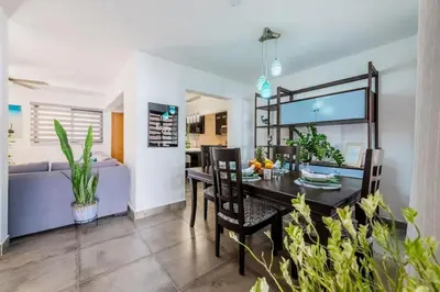 a dining room and living room with a table and chairs at Villa Sunrise an elegant private villa in Central Sosua in Sosúa