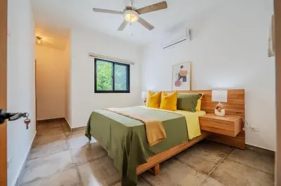 a bedroom with a bed and a ceiling fan at Villa Sunrise an elegant private villa in Central Sosua in Sosúa