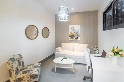 a living room with a white couch and chairs at Playa Bonita Fully Serviced Villa - Walk to Beach in Las Terrenas