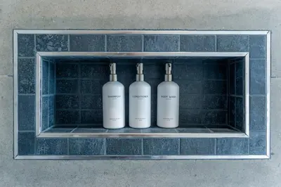 three white bottles on a shelf in a wall at Playa Bonita Fully Serviced Villa - Walk to Beach in Las Terrenas