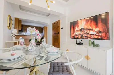 a dining room with a glass table and a fireplace at Cozy 3BR Condo in Ens. Ozama in La Cruz de Mendoza