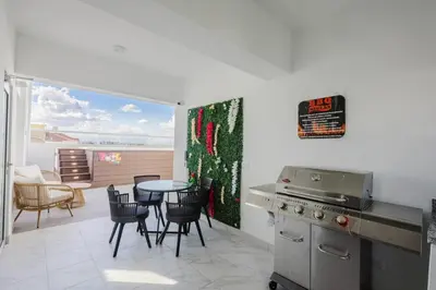 a kitchen with a table and chairs and a dining room at Cozy 3BR Condo in Ens. Ozama in La Cruz de Mendoza