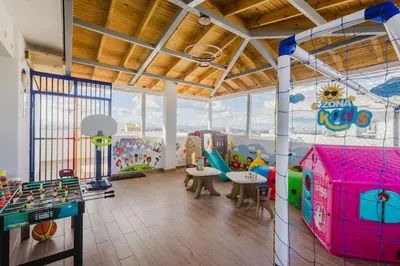 a room with a play area with tables and chairs at Cozy 3BR Condo in Ens. Ozama in La Cruz de Mendoza