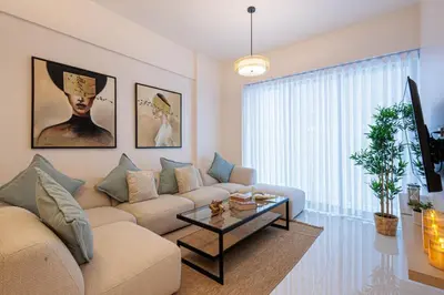 a living room with a couch and a table at Luxury City Center Condo, Roof Top Jacuzzi in Santo Domingo