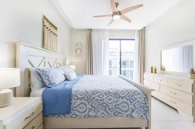 a bedroom with a bed and a ceiling fan at Stylish 1BR Apartment Near Bávaro Beach, Pool View in Punta Cana