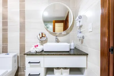 a bathroom with a sink and a mirror at Stylish 1BR Apartment Near Bávaro Beach, Pool View in Punta Cana