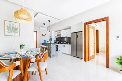 a kitchen and dining room with a table and chairs at Stylish 1BR Apartment Near Bávaro Beach, Pool View in Punta Cana