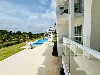 a balcony of a building with a swimming pool at Cana Pearl in Punta Cana