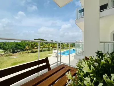 a balcony with a bench and a view of a swimming pool at Cana Pearl in Punta Cana