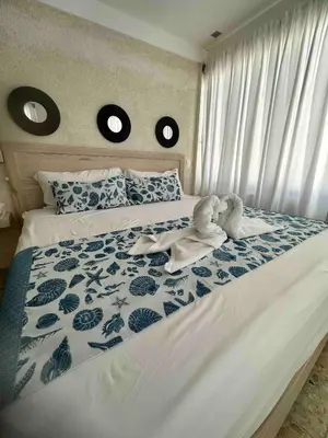 a bedroom with a bed with a blue and white comforter at Puerto Plata, beach Pent house in Maggiolo