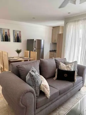 a living room with a couch and a kitchen at Puerto Plata, beach Pent house in Maggiolo