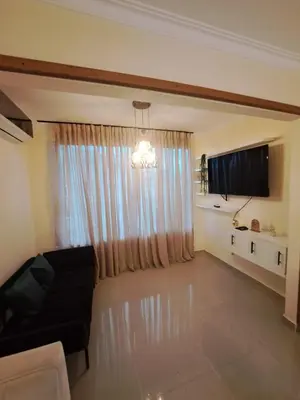 a living room with a couch and a large window at Luxurious and comfortable in the safest area in Juan López