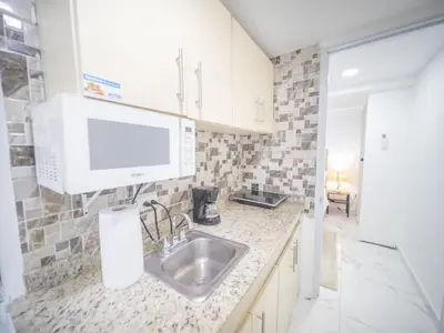 a kitchen with a sink and a microwave at Studio In Sosua Center Strip Zone in Sosúa