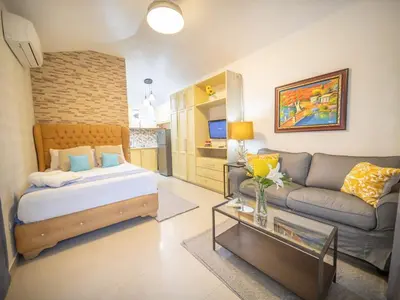 a living room with a bed and a couch at Studio in Sosua Center Near Sosua beach in Sosúa
