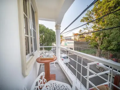 a balcony with a table and chairs and a window at Studio in Sosua Center Near Sosua beach in Sosúa